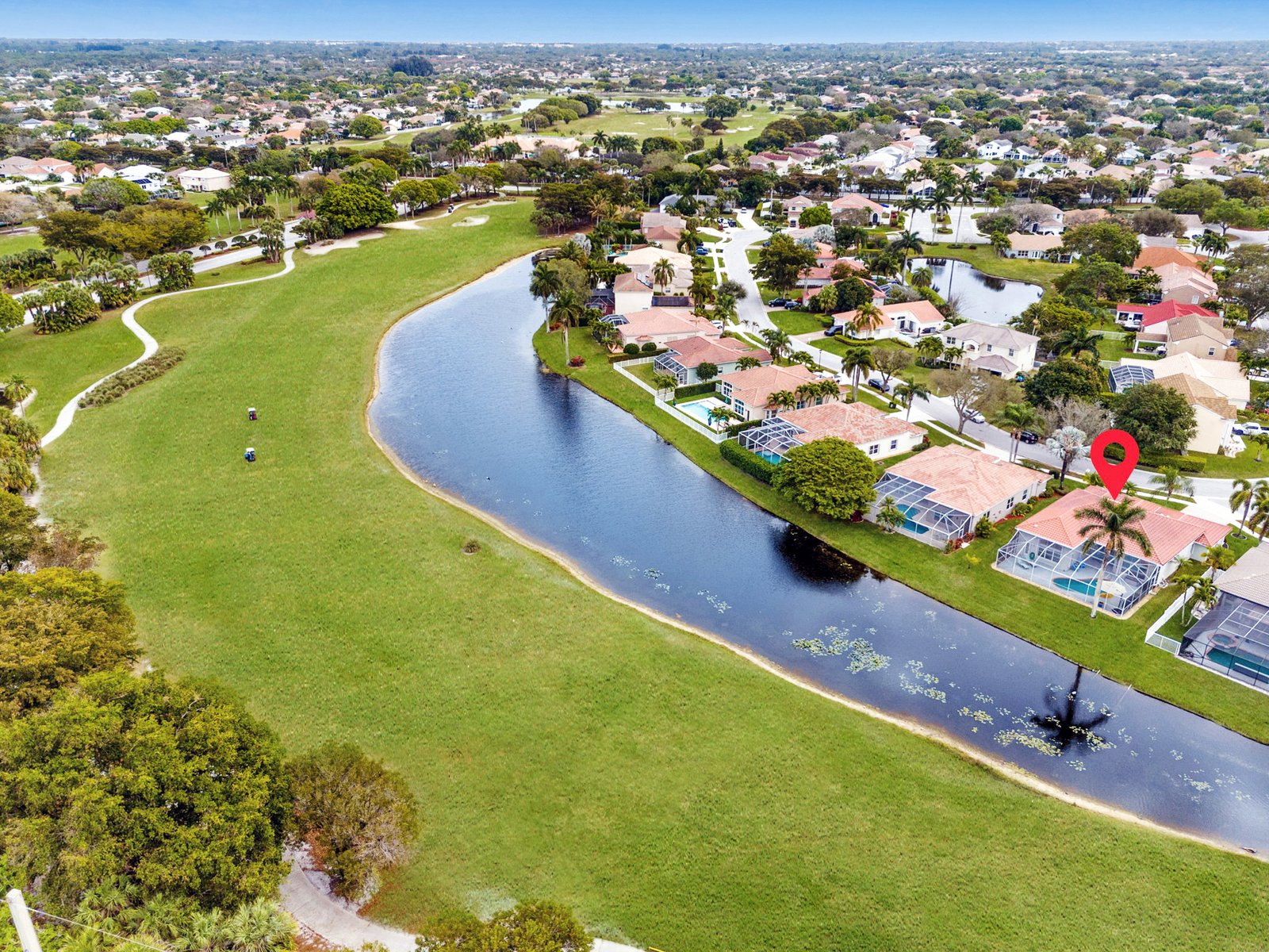 Aerial view of the community and pond behind the home